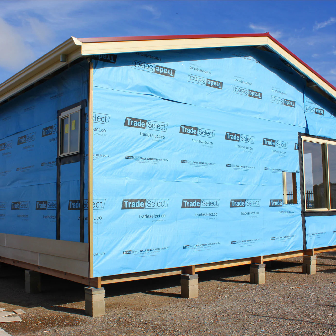 House exterior with blue siding and 'Trade Select' branding.